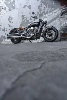 a motorcycle is parked in front of a wall