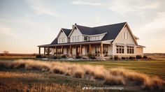 a large white house sitting on top of a lush green field next to a tall grass covered field