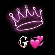 a neon sign with two hearts and a crown on it's side in the dark