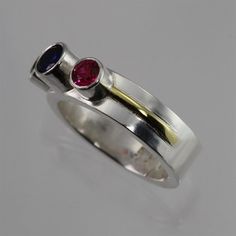 "Handcrafted sterling silver and 14 karat gold ring with 3 birthstones of your choice! Very contemporary and different than any other mother jewelry. All birthstones are lab-grown and include two 4mm and one 5mm stone. Please specify the desired birthstones, in what order at the checkout in \"note to seller\". Feel free to ask me any questions. Please allow 1-2 weeks for fabrication." Modern Multi-stone Birthstone Ring For Promise, Modern Multi-stone Birthstone Ring For Anniversary, Modern Sterling Silver Birthstone Ring For Promise, Modern Ruby Birthstone Ring For Anniversary, Modern Multi-stone Birthstone Ring, Modern Sterling Silver Ruby Ring For Anniversary, Modern Multi-stone Birthstone Ring For Gift, Modern Multi-stone Birthstone Ring As Gift, Modern Sterling Silver Birthstone Ring With Accent Stones