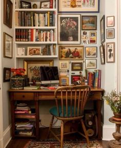 a home office with many pictures on the wall