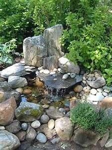 an image of a garden with rocks and water