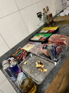 food is sitting on the counter top next to some drinks and other items that have been left out