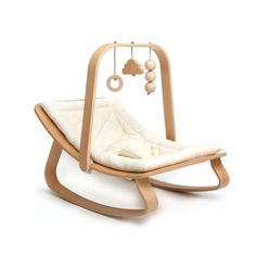 a wooden rocking chair with a white cushion on the bottom and an image of a cloud hanging from it