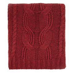 a red knitted blanket on a white background with an intricate design in the middle