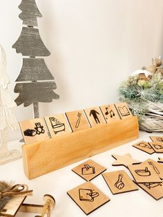 a wooden stamp set sitting on top of a table next to christmas trees and other decorations