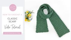 a green crochet scarf next to a bouquet of flowers