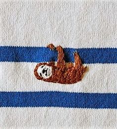 a slotty bear on a blue and white striped towel