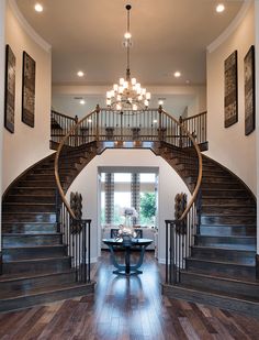 a large foyer with wooden floors and chandelier