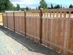 a wooden fence that is next to some dirt