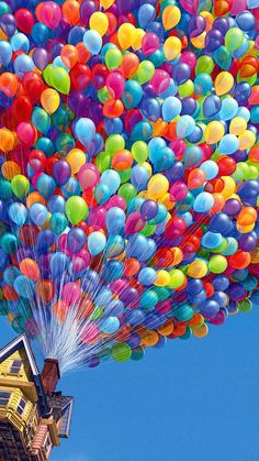 a house with many balloons floating in the air