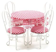 a table and four chairs with red checkered cushions