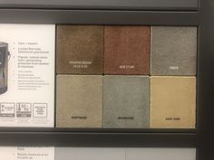 a display case with different shades of paint on the wall and below it is an advertisement for a new product