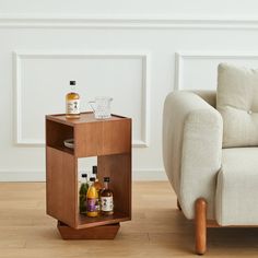 a living room with a couch and small side table on the floor next to it