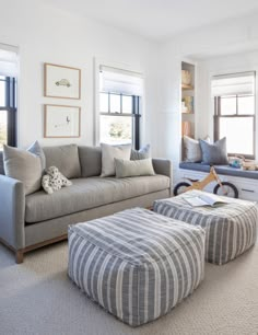 a living room filled with furniture and windows