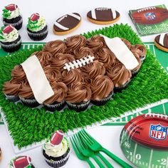 a football themed cupcake sits on top of a field with other sports related items