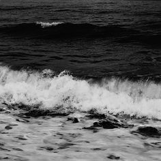 a black and white photo of the ocean waves