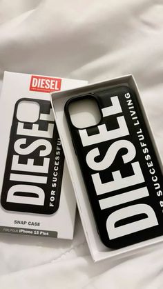 a phone case sitting on top of a white bed next to a box that says diesel