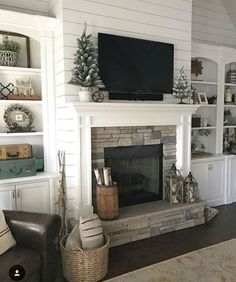 a living room filled with furniture and a flat screen tv on top of a fireplace