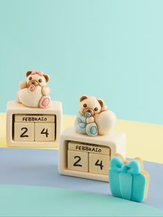 two teddy bears sitting on top of a clock