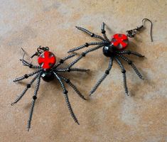 Look who`s here: Large creepy beaded spider earrings with red cross Black widow Halloween party statement jewelry Gothic style Insect dangle black earrings https://etsy.me/2N0FsI8 #Halloweenjewelry #spiderearrings #black #gothic Halloween Black Dangle Beaded Earrings For Halloween, Black Beaded Dangle Earrings For Halloween, Beaded Spider Earrings, Black Widow Halloween, Halloween Beaded Jewelry, Beaded Spiders, Spider Earrings, Jewelry Gothic, Spider Art