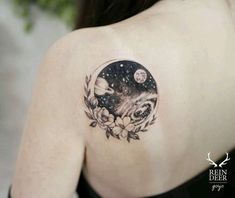 a woman with a tattoo on her shoulder has a space scene in the middle of it