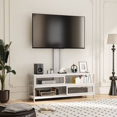 a flat screen tv sitting on top of a white entertainment center in a living room