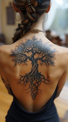 a woman with a tree tattoo on her back