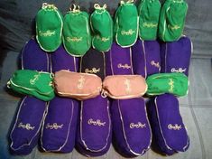 many purple and green items are lined up together