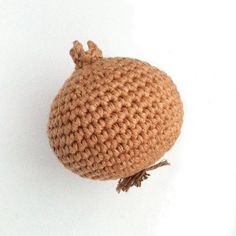 a crocheted stuffed animal sitting on top of a white surface