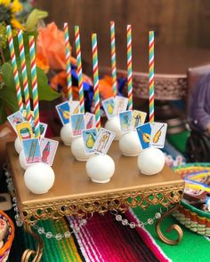 there are many candles that are on the table with other items in front of them