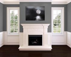 an empty living room with blue walls and white trim on the fireplace mantels