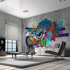 a living room with an artistic mural on the wall