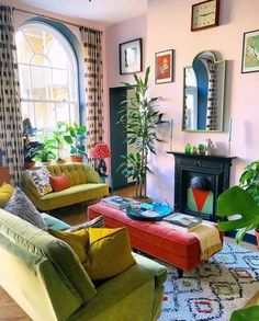 a living room filled with furniture and lots of plants