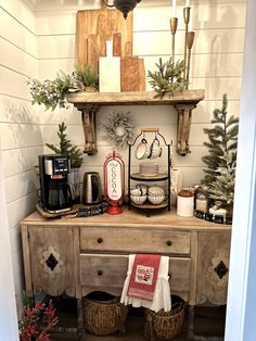 a coffee bar with christmas decorations on the top and shelf above it, along with other items