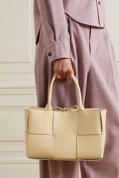 Bottega Veneta's 'Arco' tote sees the brand's signature intrecciato weave re-imagined in blown-up proportions. It's been crafted in Italy from supersized strips of full-grain leather and opens to a spacious interior. Knot the ties at the open top to keep your belongings secure. Beige Leather Bags With Interwoven Design, Bottega Veneta Bag Tote, Bottega Veneta Arco, Financial Budget, Bottega Veneta Bag, Bag Obsession, Beige Bag, Everyday Bag, Open Top