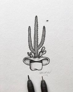 a drawing of a cactus in a hat on top of a sheet of white paper