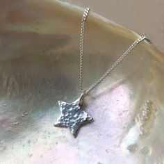 'You're a star'.   Hand hammered sterling silver star necklace.  A top quality shiny star charm rests upon a sleek 925 sterling silver chain. This sweet celestial charm makes a lovely dainty gift.   Simple to layer with other necklaces or just on its own!  Matching earrings - https://etsy.me/2PWyo0v* Star charm approx 15mm-17mm (0.6 inch), sterling silver * Sterling silver chain, spring ring clasp, choice of lengthsPlease check measurements as photos make things look larger.Packaged securely in Sterling Silver Necklace With Star Charm For Gifting, Sterling Silver Necklace With Star Charm As Gift, Gift Sterling Silver Necklace With Star Charm, Handmade Star Shaped Sterling Silver Necklace, Silver Hammered Charm Necklace As Gift, Silver Hammered Charm Necklace Gift, Hammered Sterling Silver Charm Necklace As Gift, Dainty Sterling Silver Star Of David Necklace, Dainty Silver Star Of David Necklace