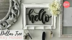 there is a key holder with the word hello written on it next to a mirror