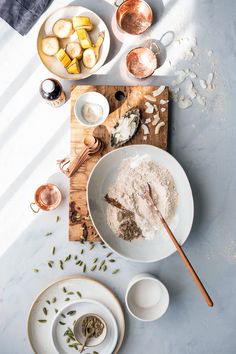 a table with bowls, plates and utensils on it that include ingredients to make an appetizer