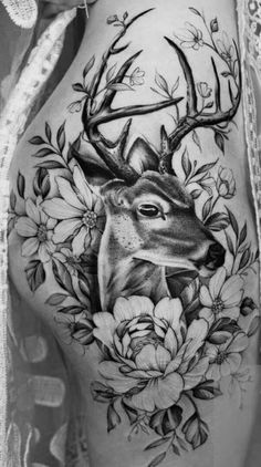 a woman's stomach with an antelope and flowers on it