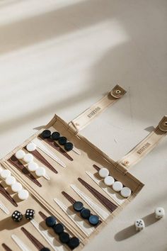 an assortment of buttons and pins in a bag on a table next to a pair of scissors