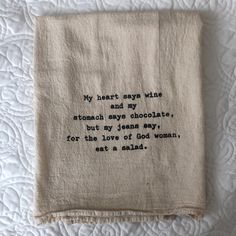 an embroidered tea towel with words on it