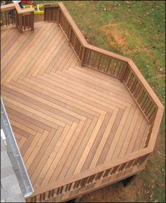 an overhead view of a wooden deck in a yard with two children playing on it