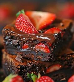 two chocolate brownies with strawberries on top