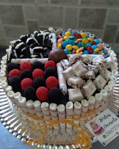 a close up of a cake on a plate with many different toppings in it