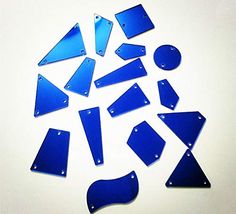 several pieces of blue glass sitting on top of a white table