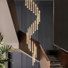 a staircase with chandelier hanging from it's side