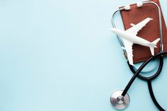 a stethoscope laying on top of a brown leather case with a white airplane on it