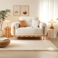 a living room filled with white furniture and lots of pillows on top of it's covers